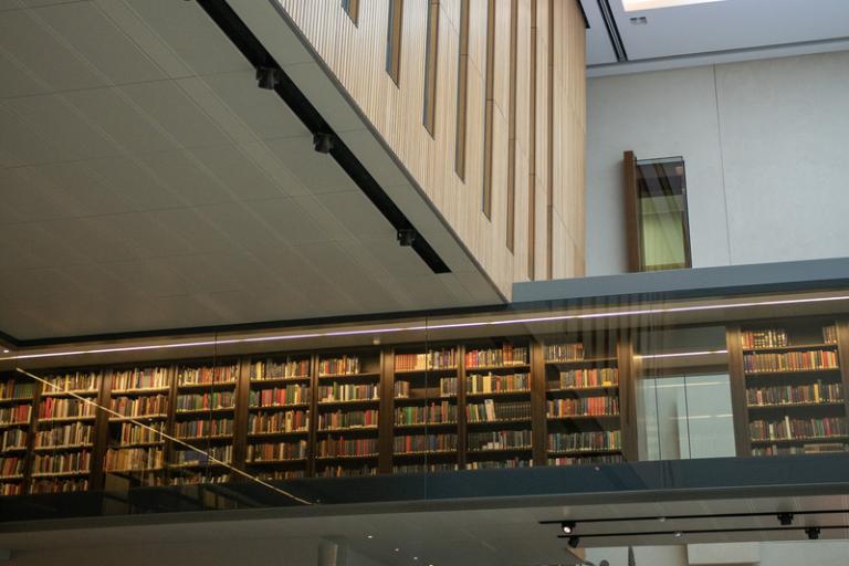A library corridor hangs suspended above an atrium.